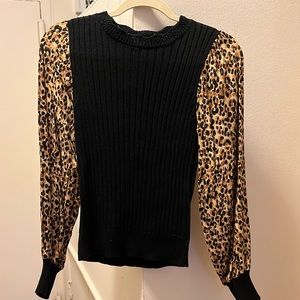 Black top with cheetah print sleeves